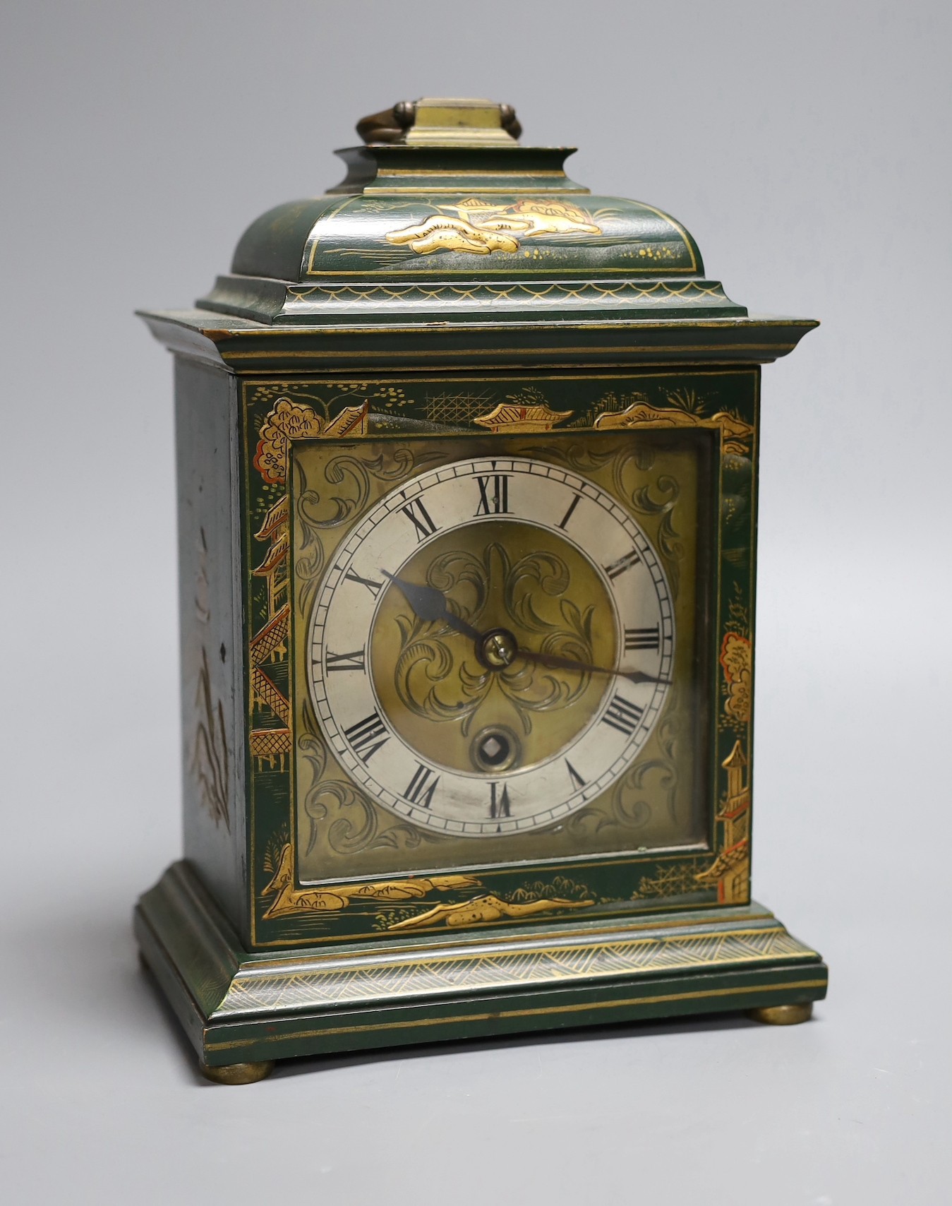 A 1920's green japanned mantel timepiece, 26 cms high